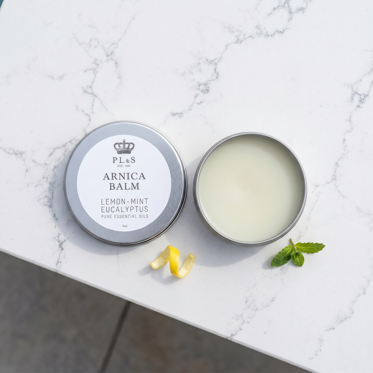 a jar of arnica balm on a marble surface