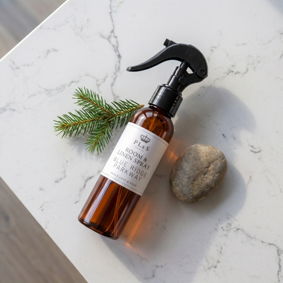 a spray bottle with a sprayer on top of a marble surface