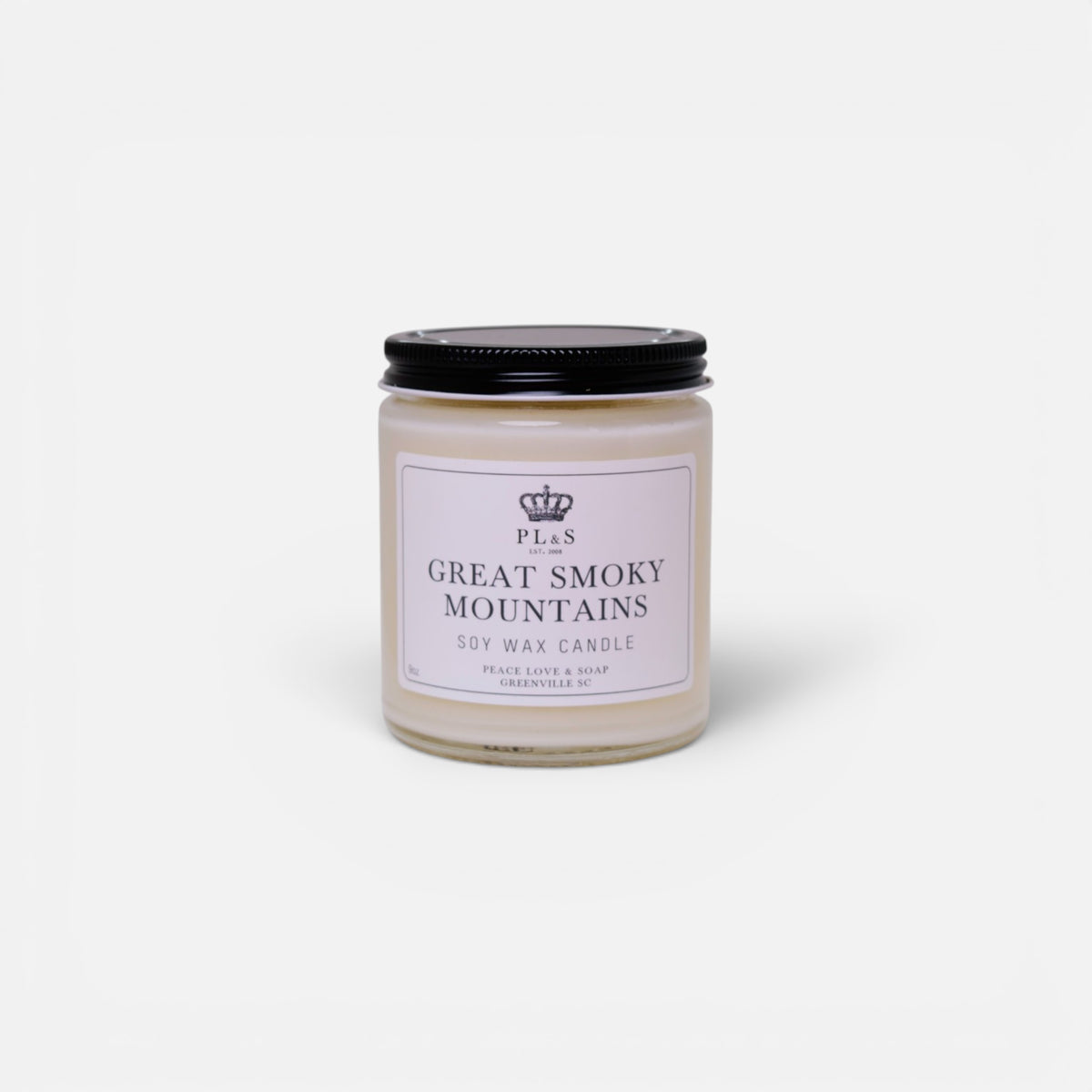 a white candle with black lid