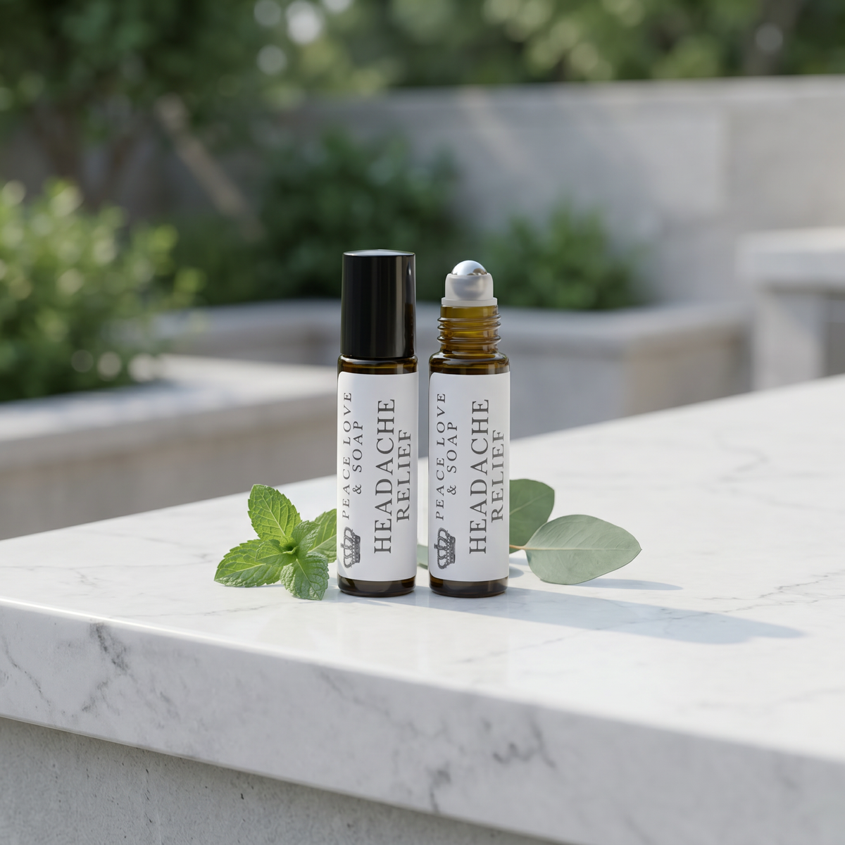 two bottles of essential oils on a marble surface