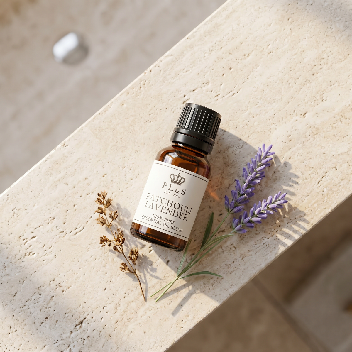 a small bottle of essential oil and lavender flowers