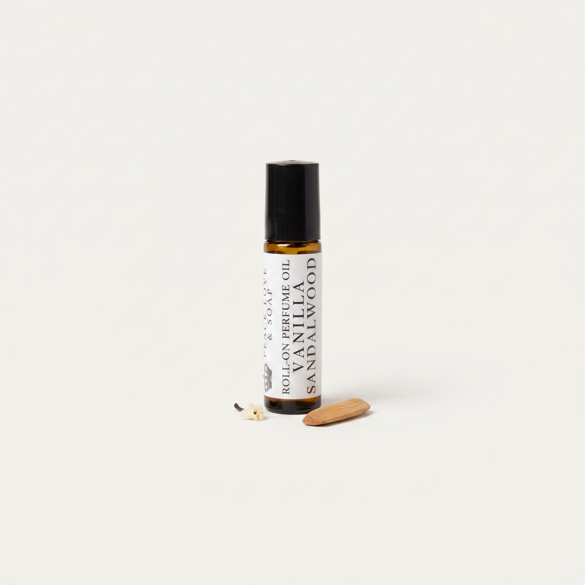 a small bottle of essential oil next to a small wooden object
