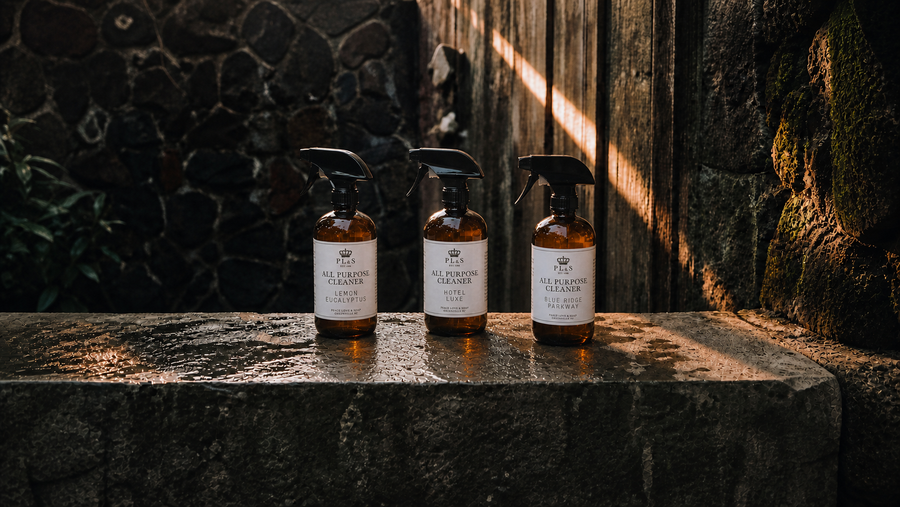 Peace Love & Soap All Purpose Cleaner collection featuring Lemon Eucalyptus, Hotel Luxe, and Blue Ridge Parkway in a moody garden setting