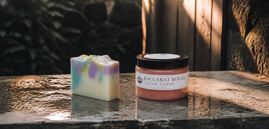 Peace Love & Soap bath collection on a wet garden stone ledge