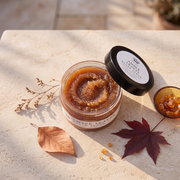 a jar of brown scrub next to a bowl of brown liquid