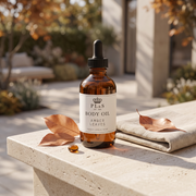 a bottle of body oil on a stone surface