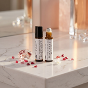 two small bottles of essential oils on a marble counter