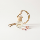 a small glass bottle with a wooden cap and a rope