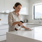 a woman cleaning a kitchen counter