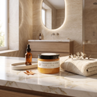 a bathroom counter with a towel and a jar of body butter