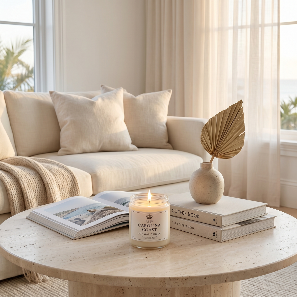 a coffee table with a candle and books on it