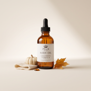 a bottle of body oil next to a white object