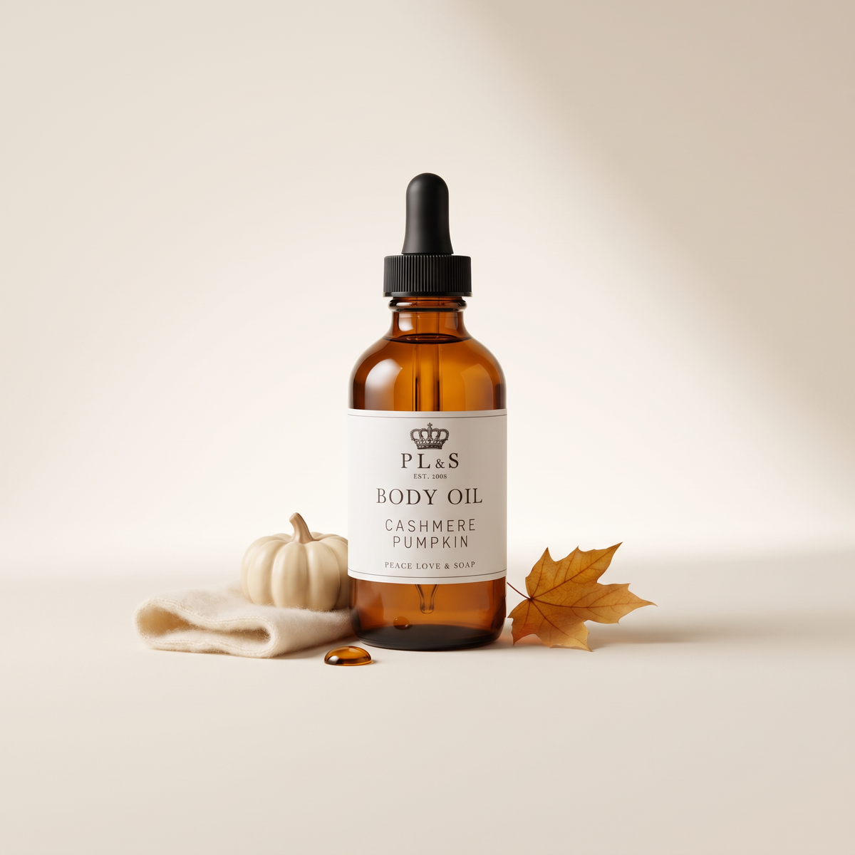 a bottle of body oil next to a white object