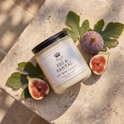 a candle with figs on a stone surface