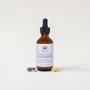 a bottle of face serum with a dropper and lavender