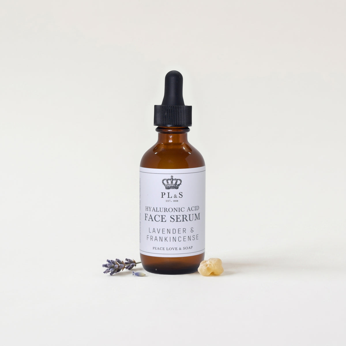 a bottle of face serum with a dropper and lavender