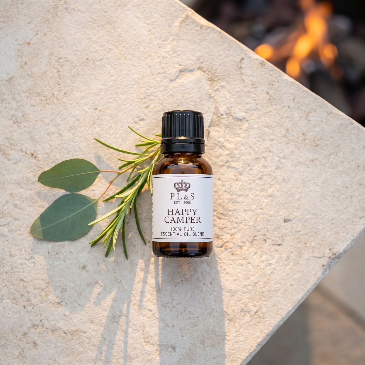 a small bottle of essential oil with a plant on a stone surface