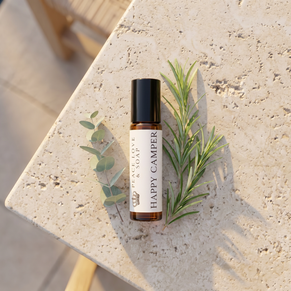 a small bottle of essential oil with a leaf on a table