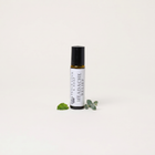 a small bottle of essential oil with leaves