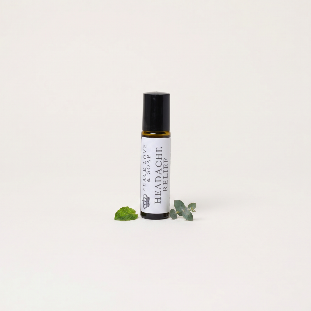 a small bottle of essential oil with leaves