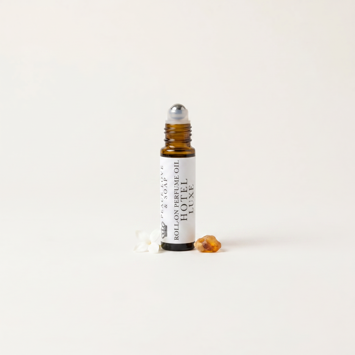 a small bottle of essential oil with a small piece of candy