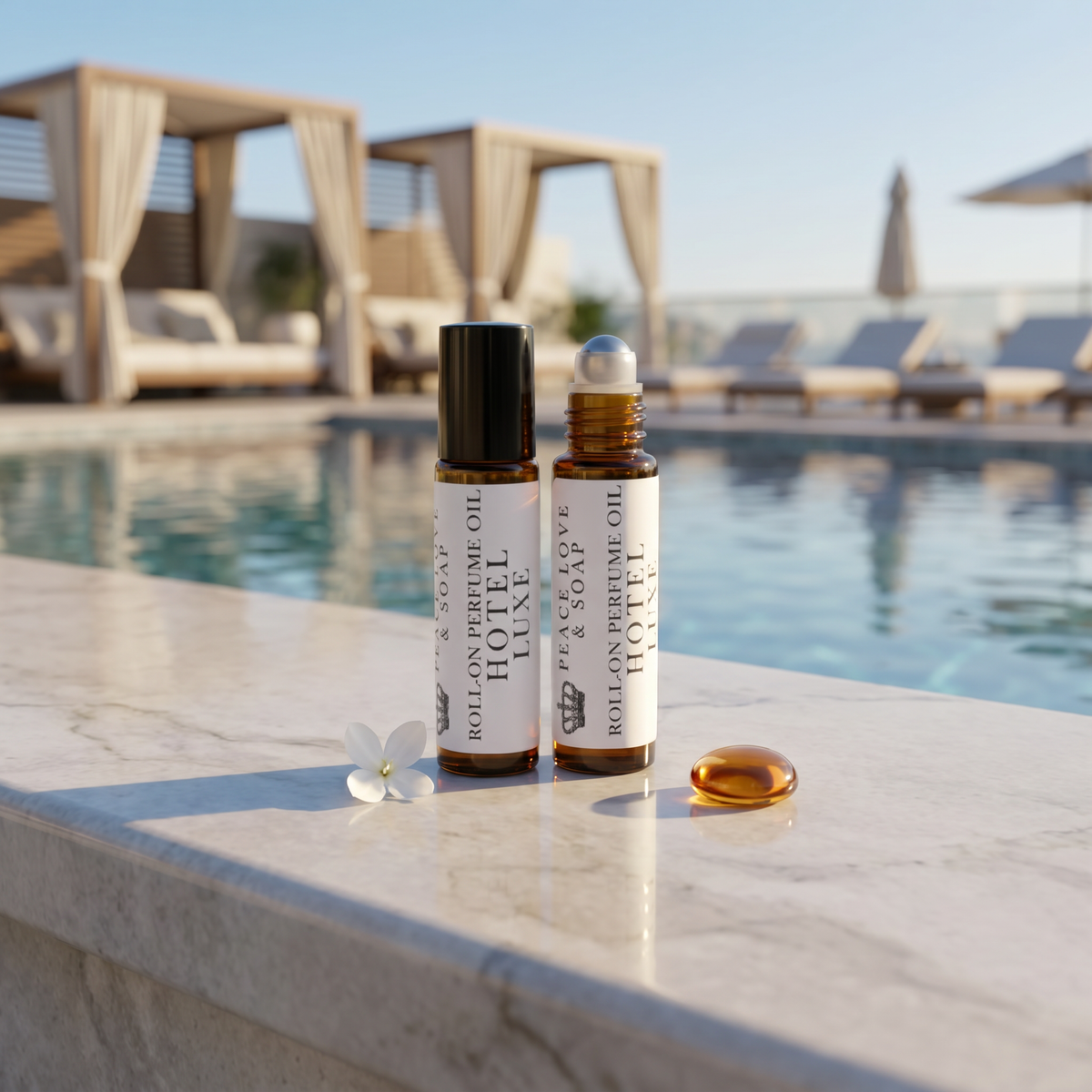 two bottles of essential oil next to a pool