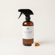 a bottle of cleaning spray and a small white flower