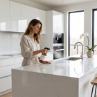 a woman holding a bottle in a kitchen