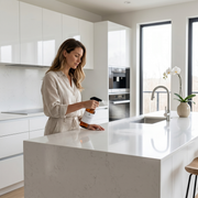 a woman holding a bottle in a kitchen