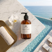 a soap bottle and towel on a marble surface