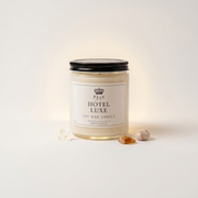 a glass jar with a white label and a black lid