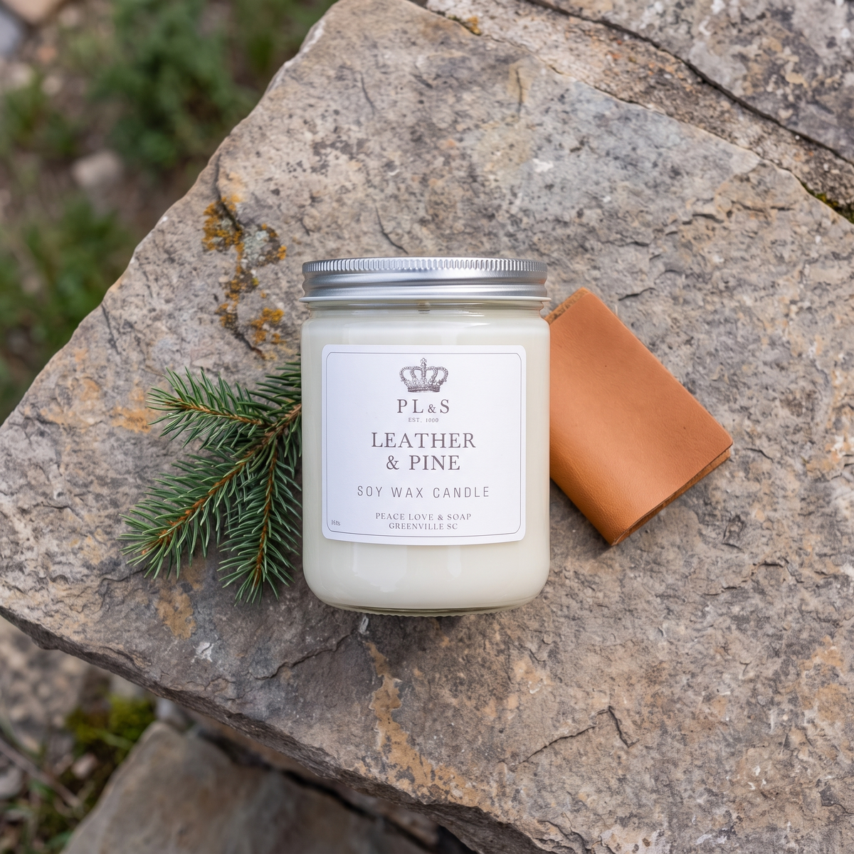 a white candle on a rock