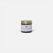 a small glass jar with a gold lid