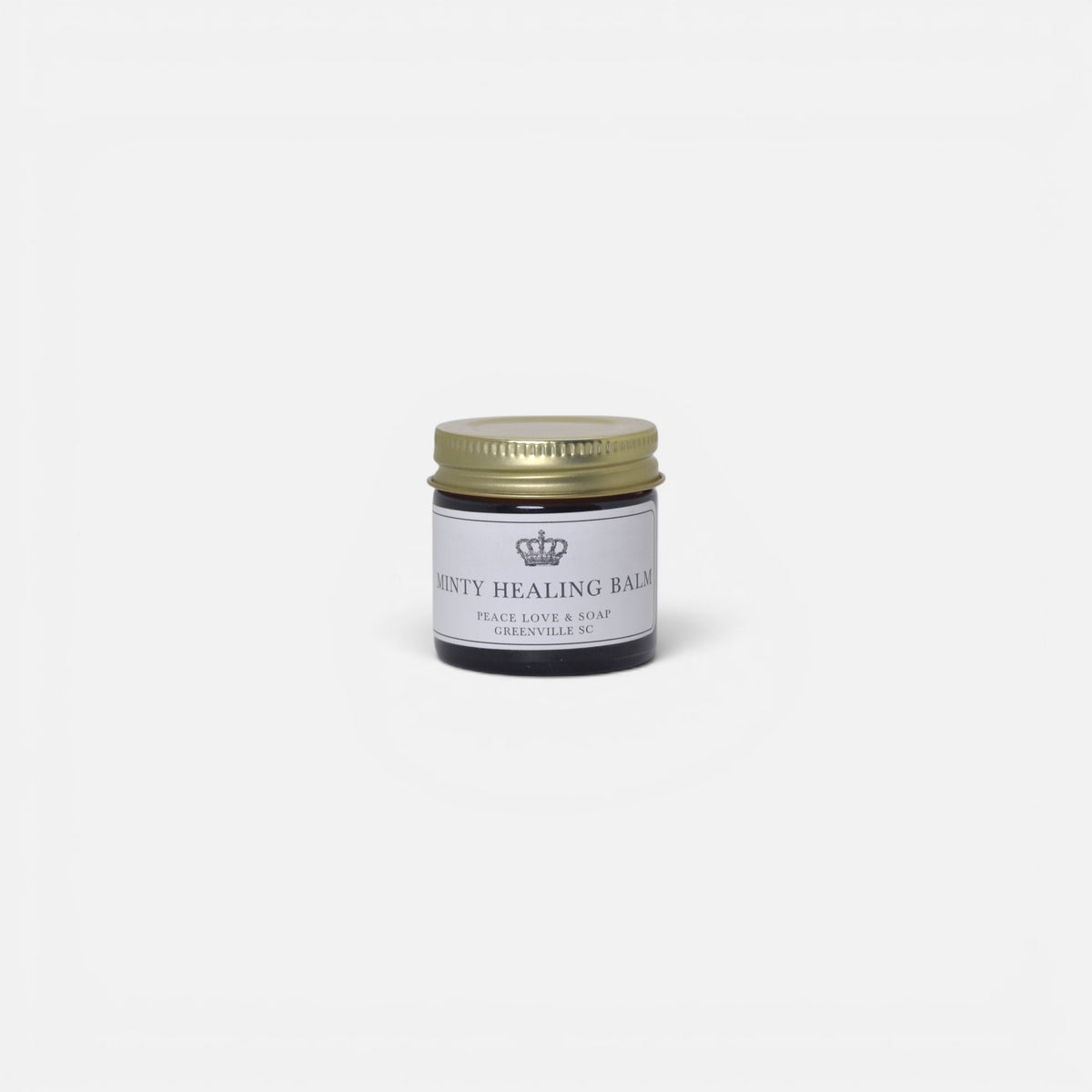 a small glass jar with a gold lid