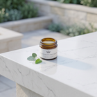 a jar of cream on a marble surface
