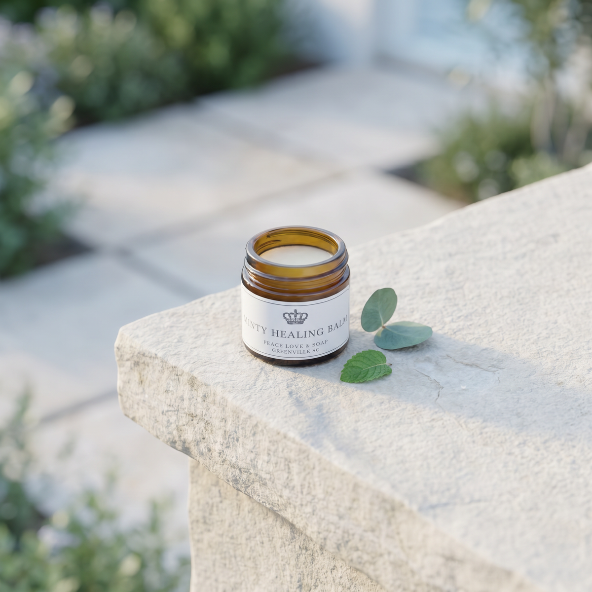 a small glass jar with a white label on a stone ledge