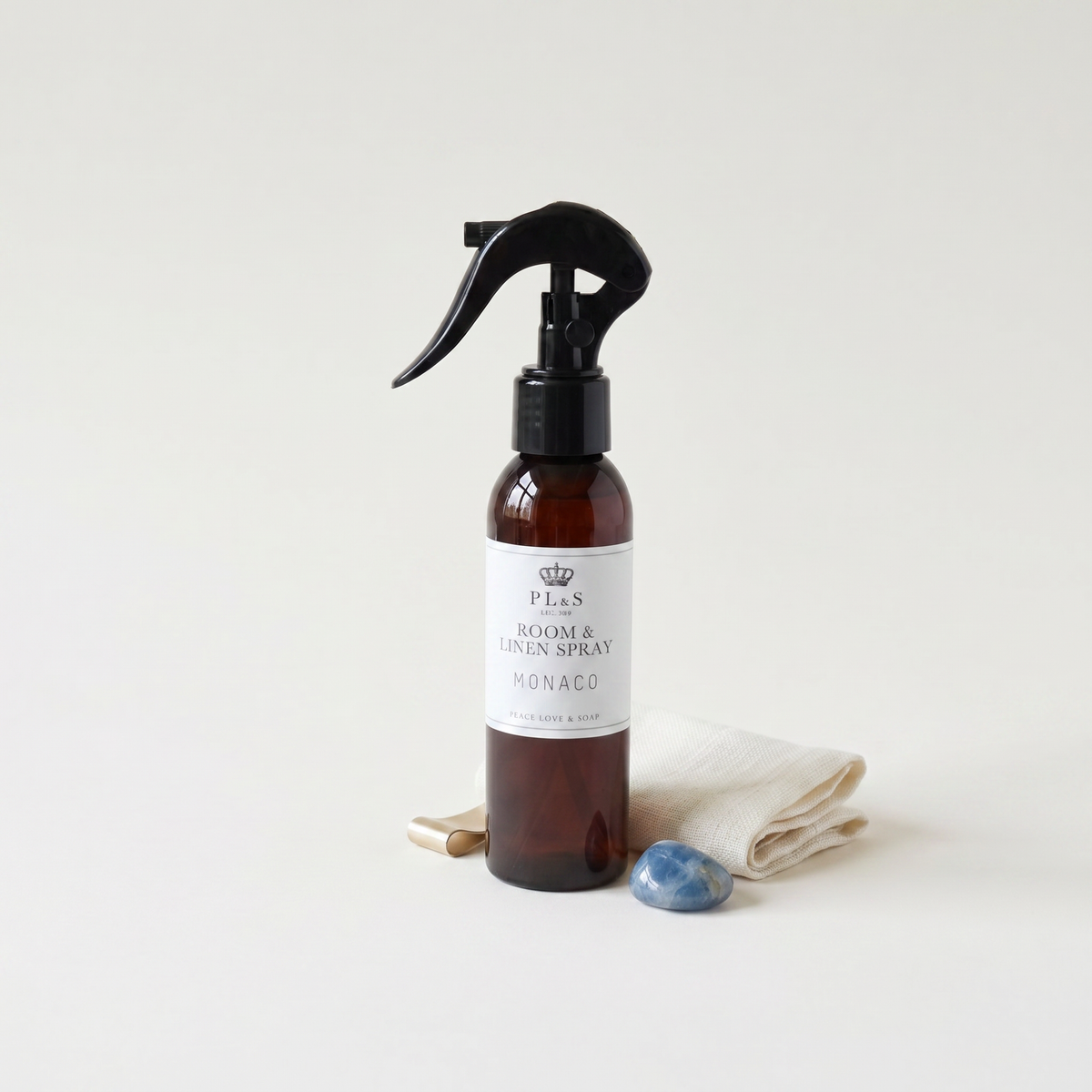 a spray bottle with a black sprayer and a white towel