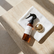 a bottle of liquid on a towel