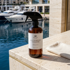 a bottle of cleaning spray on a ledge next to a body of water