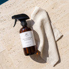 a bottle of cleaning spray and a towel