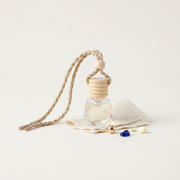 a small glass bottle with wooden rings and beads