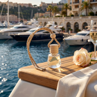 a rose and a bottle of perfume on a table with a glass of champagne
