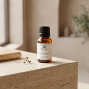 a small bottle of essential oil on a stone surface