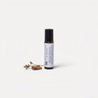 a small bottle of essential oil next to a small brown object