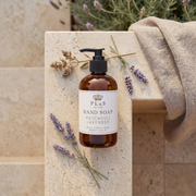 a bottle of soap on a stone surface