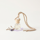 a small glass bottle with a string and a small flower