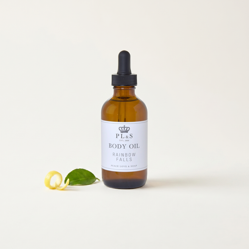 a bottle of body oil with a dropper