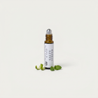 a small bottle with a dropper next to some leaves