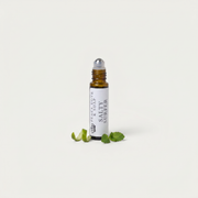 a small bottle with a dropper next to some leaves