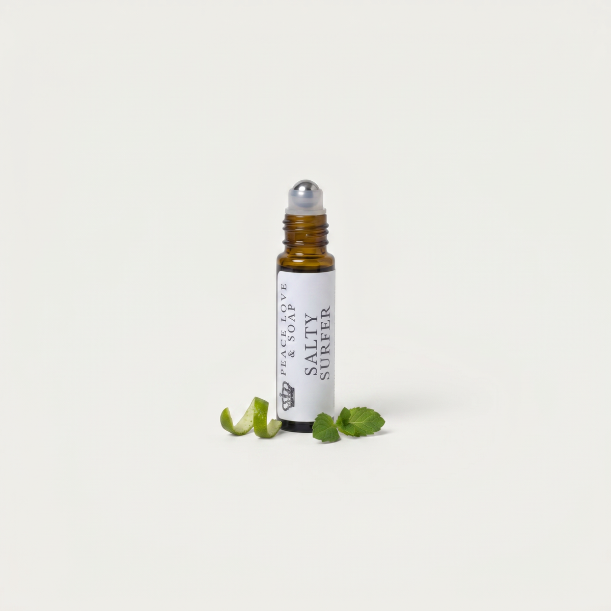 a small bottle with a dropper next to some leaves